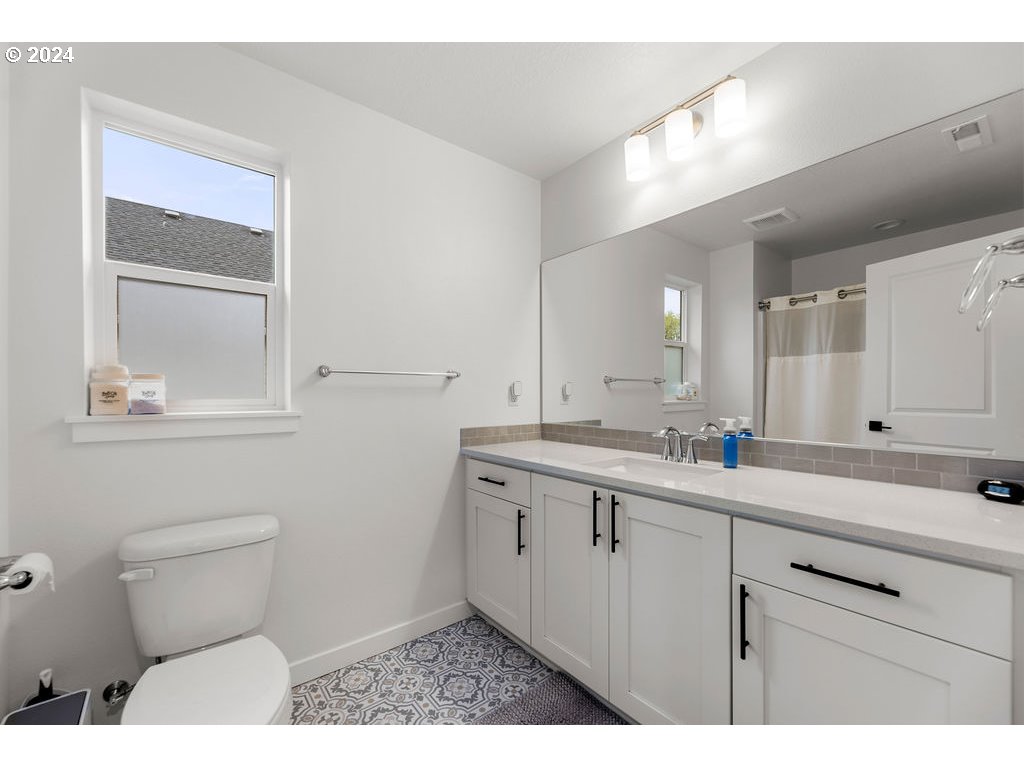 940 South Sevier Road Ridgefield, WA 98642 - Photo 12 of 21 a bathroom with a toilet sink and mirror