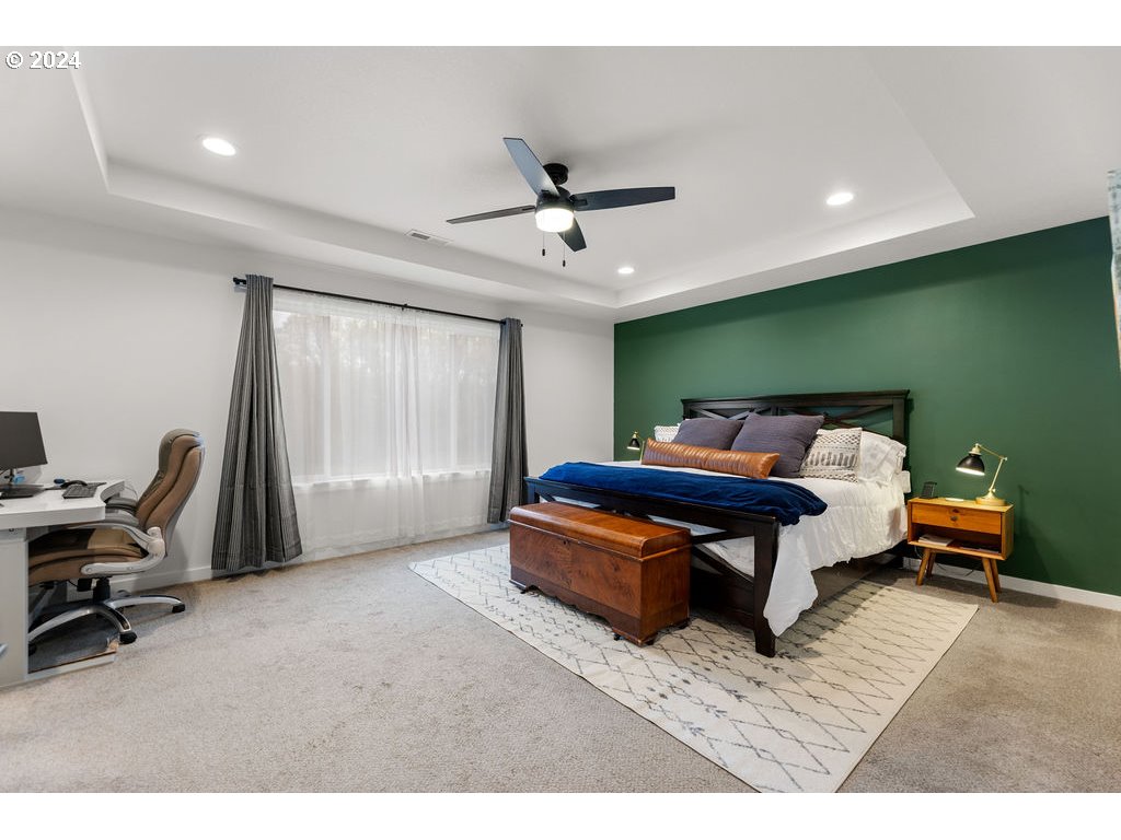 940 South Sevier Road Ridgefield, WA 98642 - Photo 13 of 21 a bedroom with a bed and a chandelier