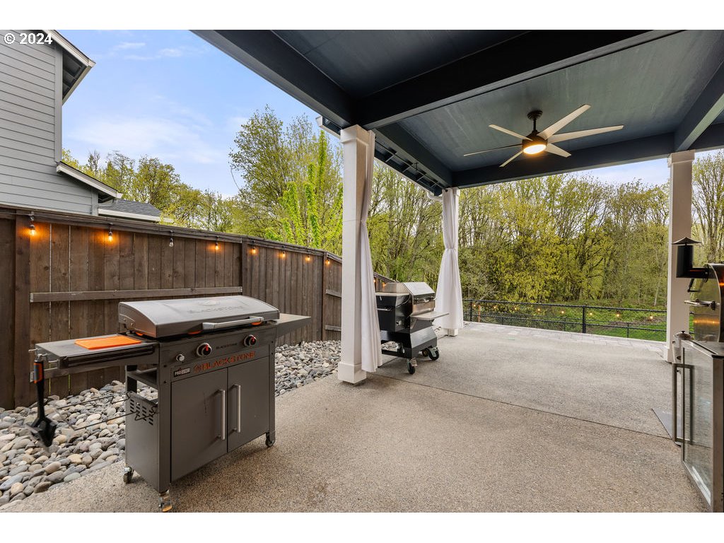 940 South Sevier Road Ridgefield, WA 98642 - Photo 17 of 21 a view of a patio with a table chairs and a grill