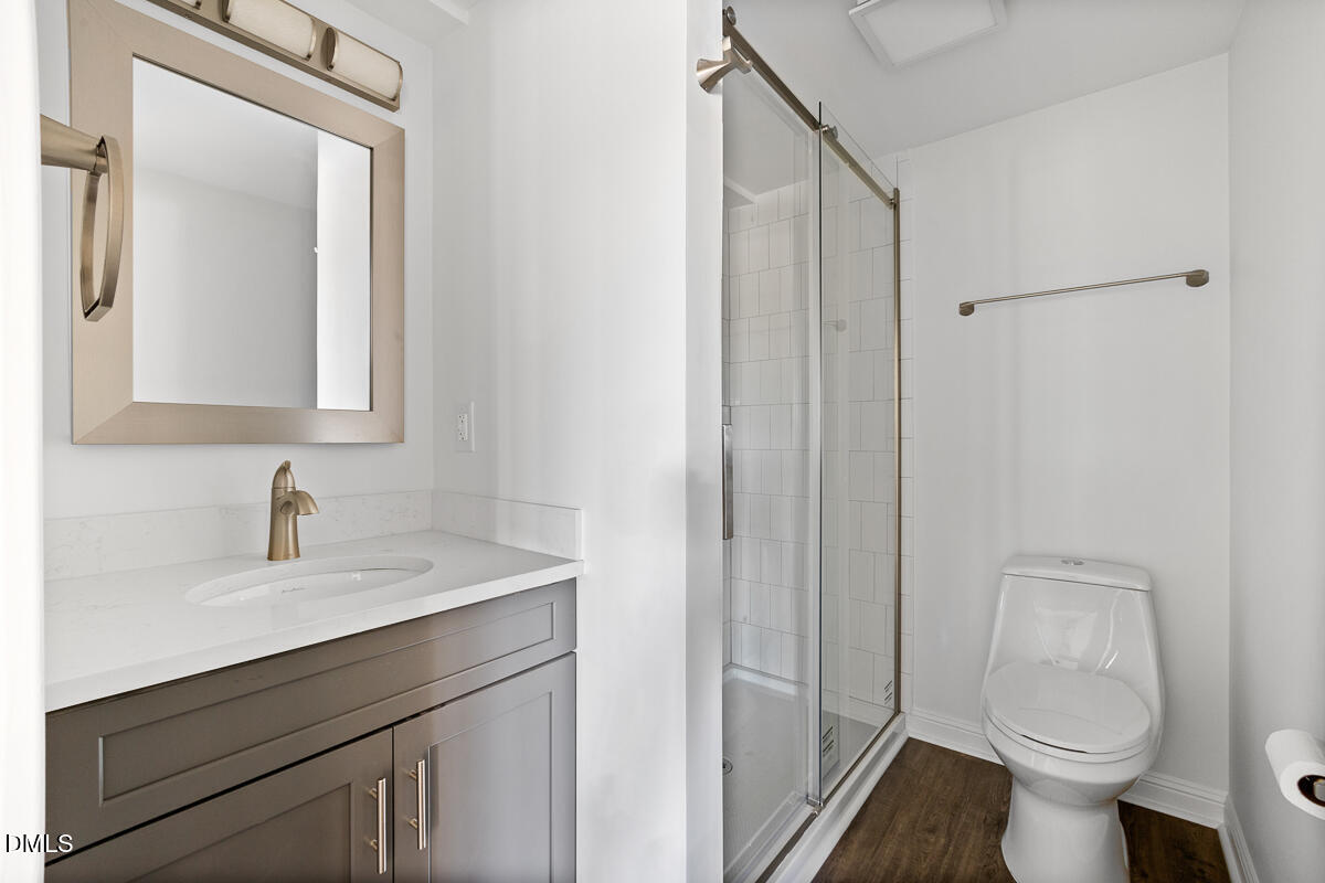 7700 Humie Olive Road Apex, NC 27502 - Photo 7 of 13 a bathroom with a sink toilet and shower
