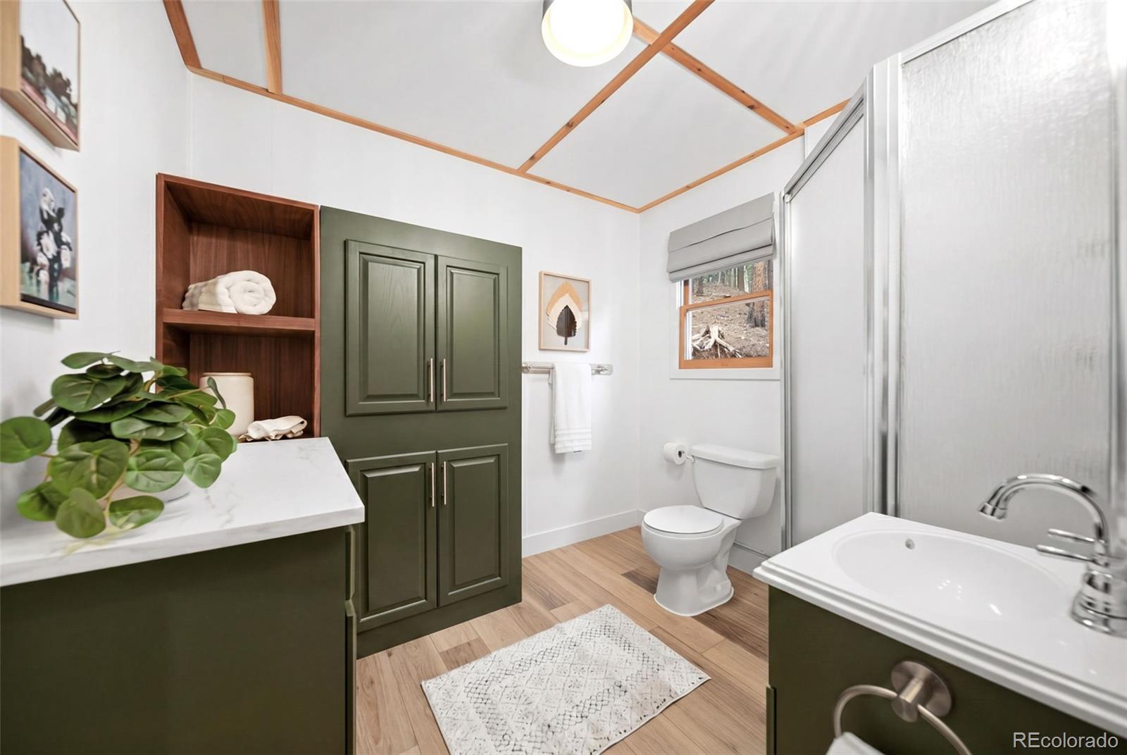 154 Apache Road Evergreen, CO 80439 - Photo 15 of 30 a bathroom with a sink a toilet and mirror