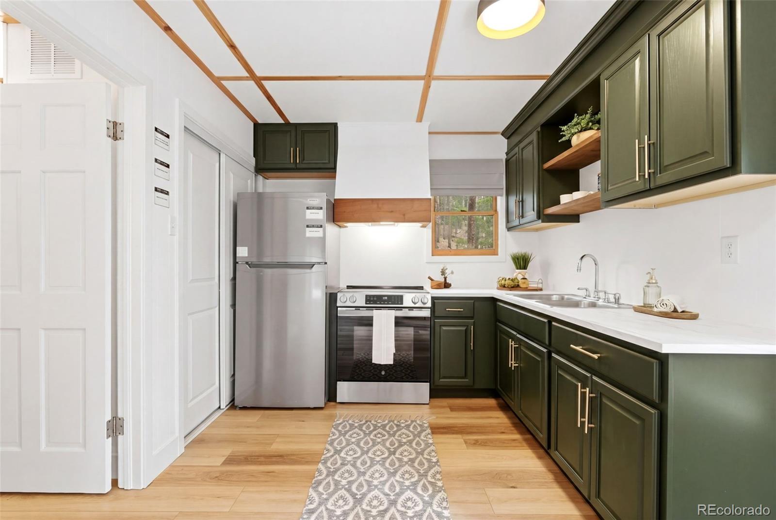 154 Apache Road Evergreen, CO 80439 - Photo 2 of 30 a kitchen with stainless steel appliances granite countertop a refrigerator and a sink