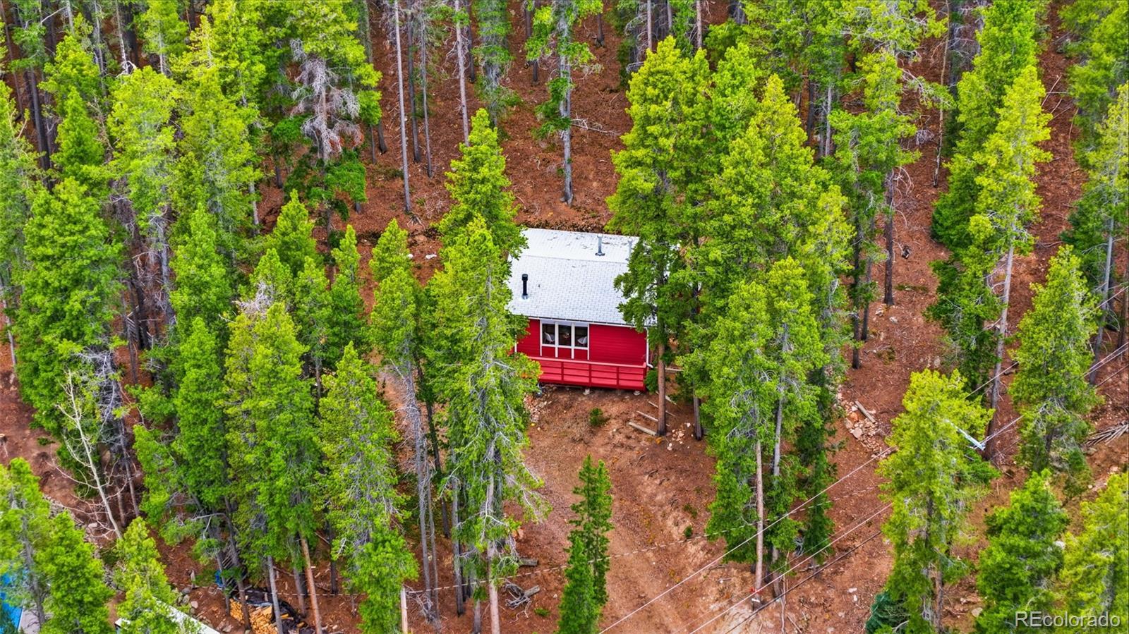 154 Apache Road Evergreen, CO 80439 - Photo 29 of 30 a sign that is sitting in a forest