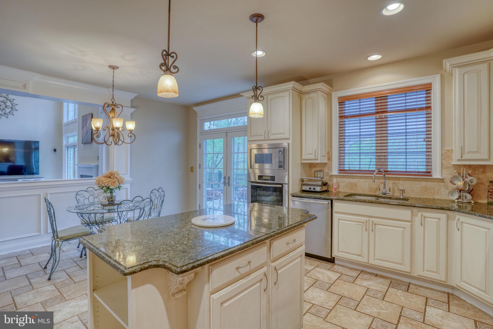 357 Willits Way Garnet Valley, PA 19060 - Photo 27 of 63 a kitchen with center island white cabinets and a chandelier