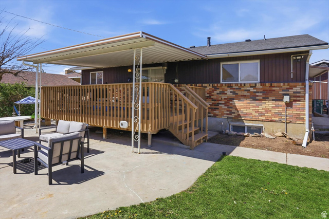 5108 South 2000th Street West Roy, UT 84067 - Photo 54 of 61 Rear view of property featuring outdoor lounge area, brick siding, a deck, and roof with shingles