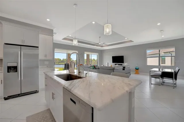 a kitchen with granite countertop a stove and a white cabinets