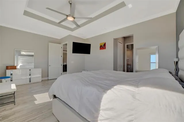 a room with furniture a air conditioner and a ceiling fan