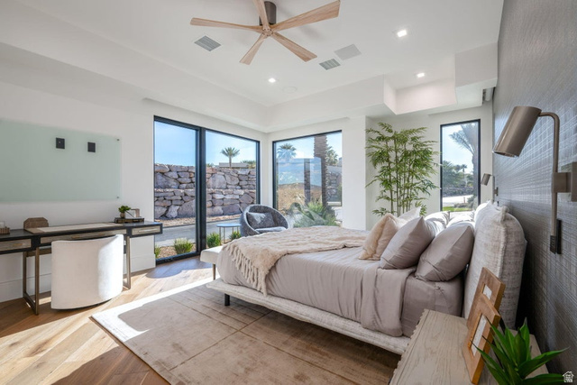 2867 East Granite Way St. George, UT 84790 - Photo 52 of 69 Bedroom featuring wide plank wood-finish flooring, a contemporary ceiling fan, recessed lighting, and expansive windows