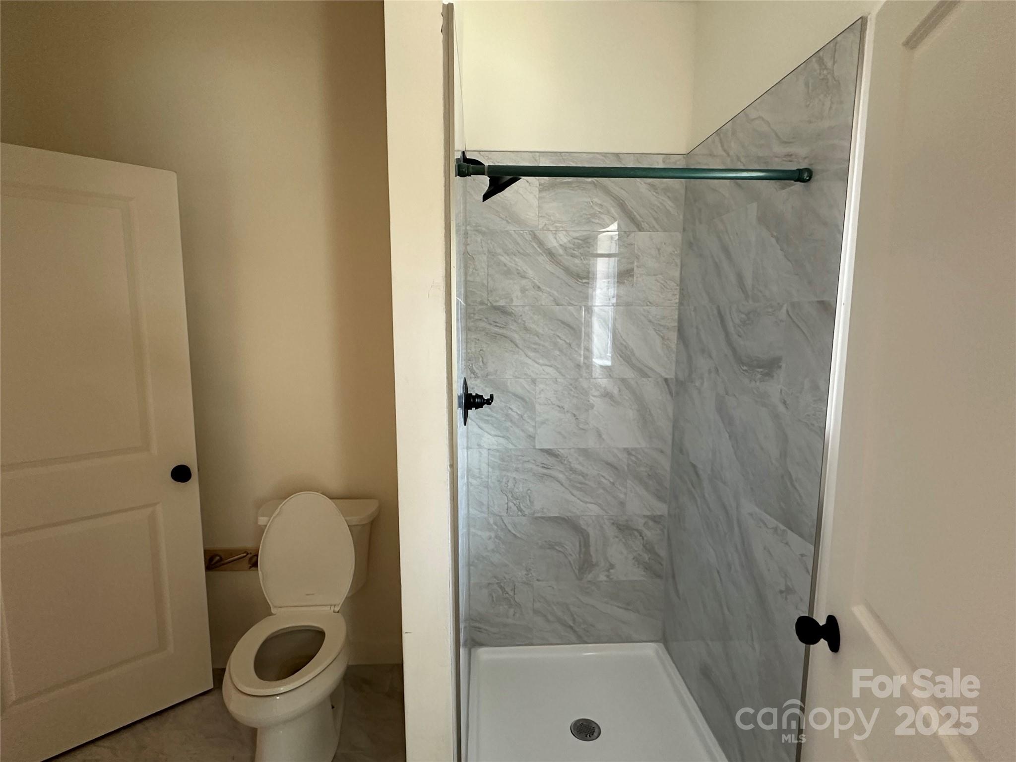 1409 Enochville Road Kannapolis, NC 28081 - Photo 7 of 14 a bathroom with a granite countertop shower and a toilet