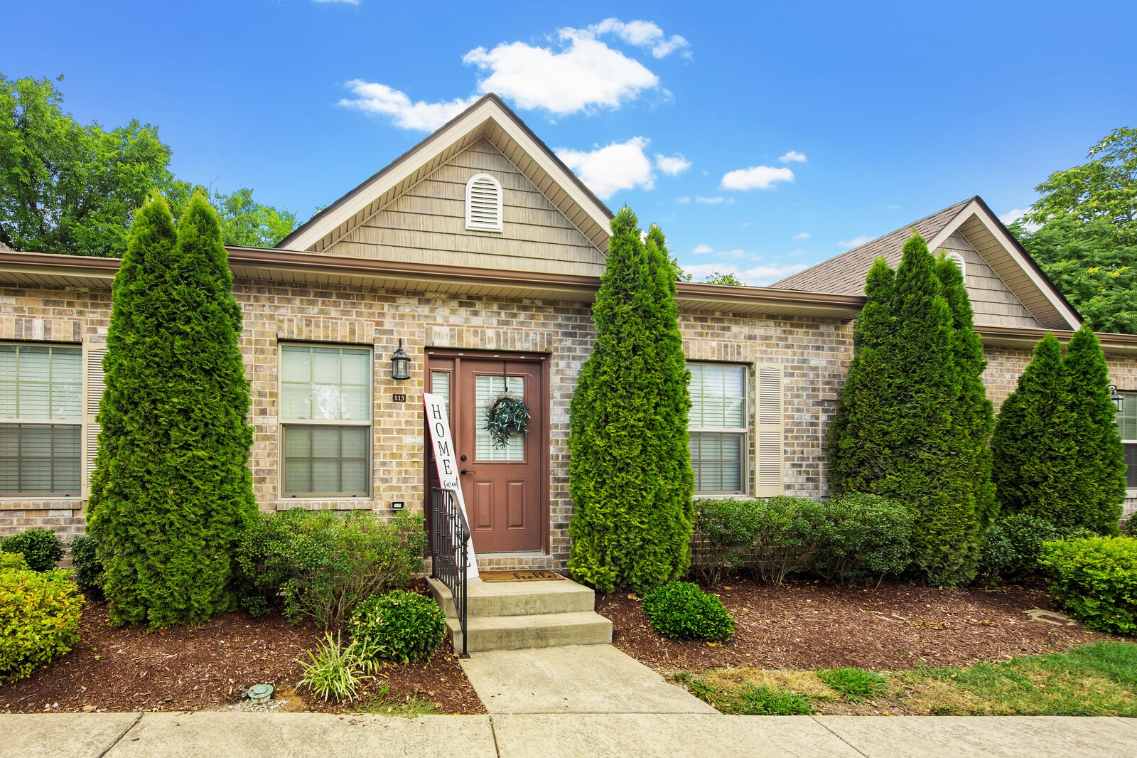 a front view of a house with garden