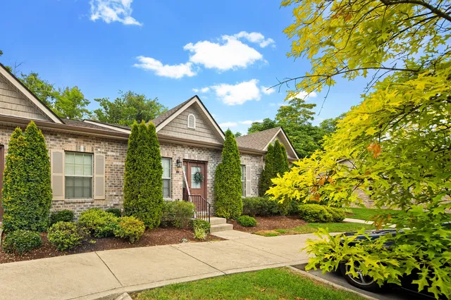 a view of a brick house with a yard