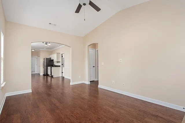 a view of empty room with wooden floor