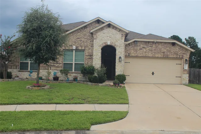 a front view of a house with a yard and garage