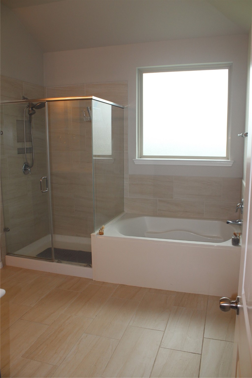 14200 Wallowa Ridge Lane Conroe, TX 77384 - Photo 12 of 22 a bathroom with a bathtub a toilet and a shower