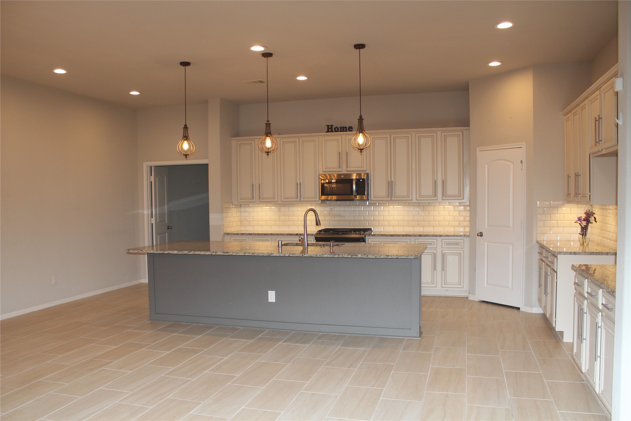 14200 Wallowa Ridge Lane Conroe, TX 77384 - Photo 4 of 22 a large kitchen with stainless steel appliances a large counter top a stove a sink and a refrigerator