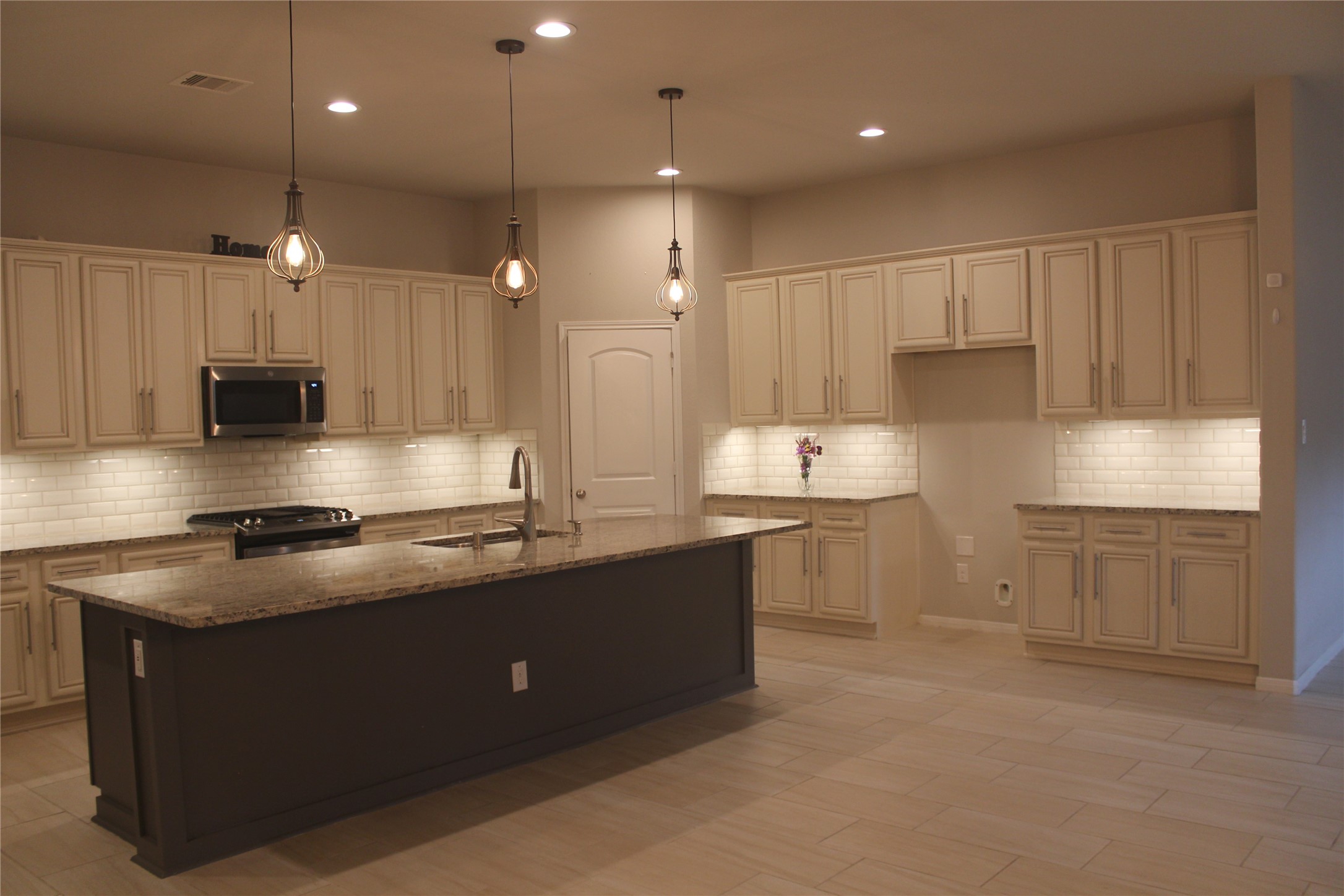 14200 Wallowa Ridge Lane Conroe, TX 77384 - Photo 5 of 22 a kitchen with stainless steel appliances granite countertop a sink a stove and a refrigerator