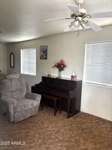 a living room with furniture and a piano