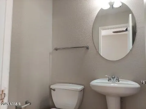 a bathroom with a sink toilet and a mirror
