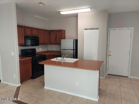 1505 East Chipman Road Phoenix, AZ 85040 - Photo 4 of 15 a kitchen with stainless steel appliances granite countertop a stove a refrigerator and a view of living room