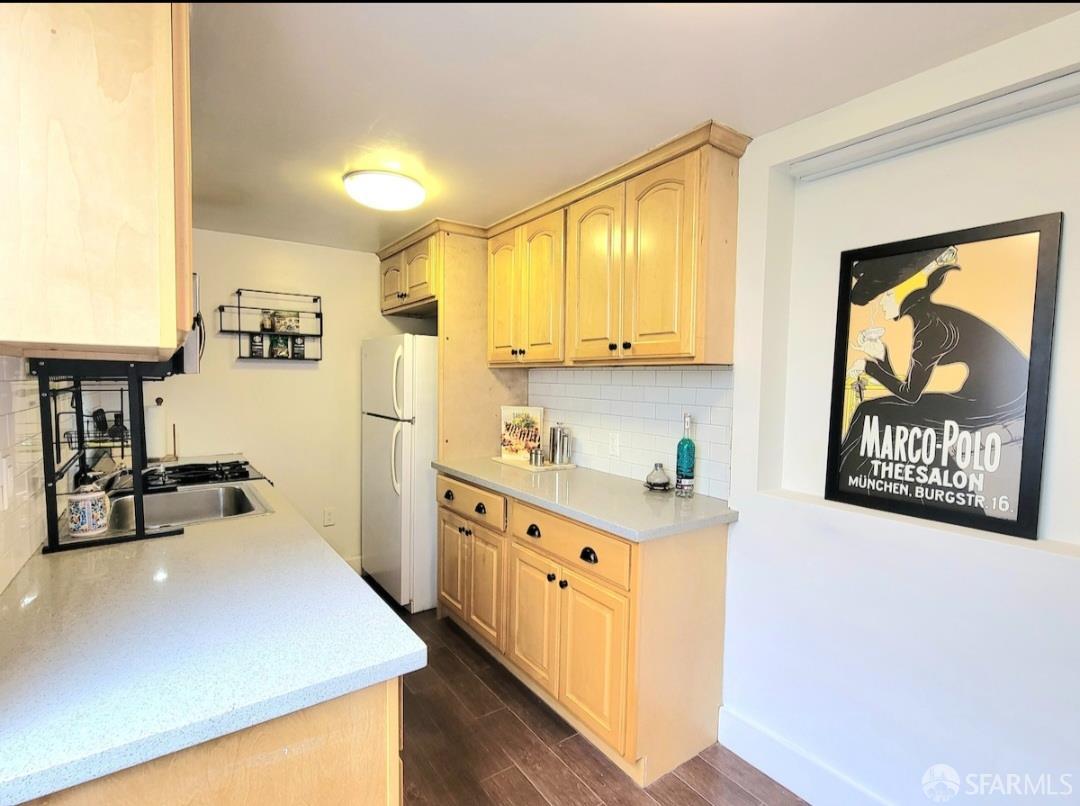 365 22nd Avenue San Francisco, CA 94121 - Photo 4 of 22 a kitchen with stainless steel appliances a refrigerator a sink and white cabinets