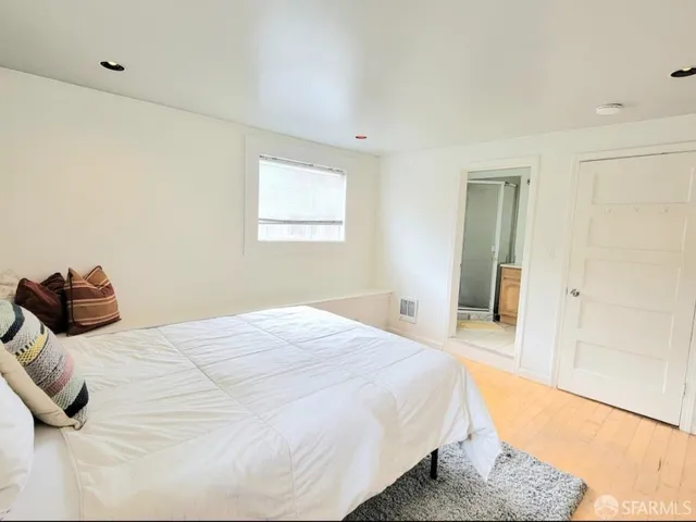 a bedroom with a bed and a painting