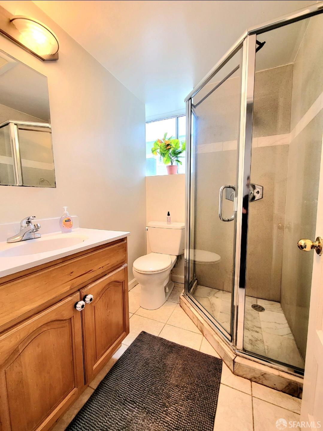 365 22nd Avenue San Francisco, CA 94121 - Photo 10 of 22 a bathroom with a sink and mirror with toilet