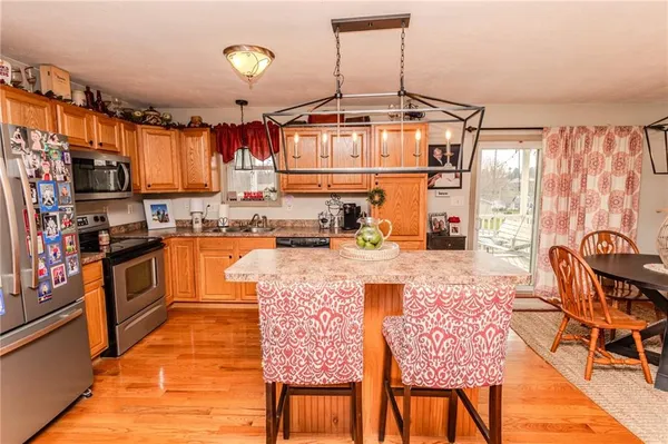 a kitchen with stainless steel appliances granite countertop a stove a sink dishwasher and a refrigerator