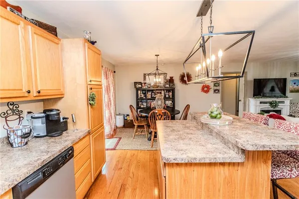 a living room with furniture and a kitchen view