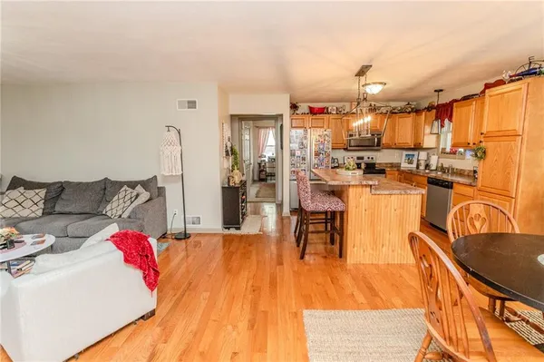 a dining room with furniture and wooden floor