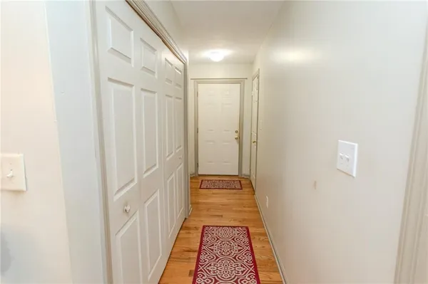 a bedroom with a bed and a flat tv screen on a dresser