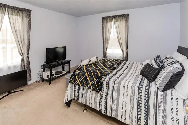 a bedroom with a bed and a lamp
