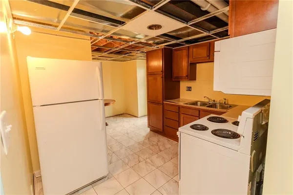 a kitchen with a refrigerator and a stove