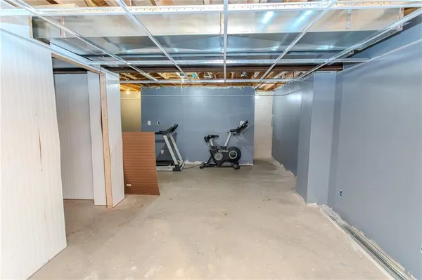 a room with water heater and wooden walls