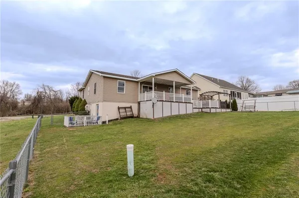 a view of a house with a garden and deck