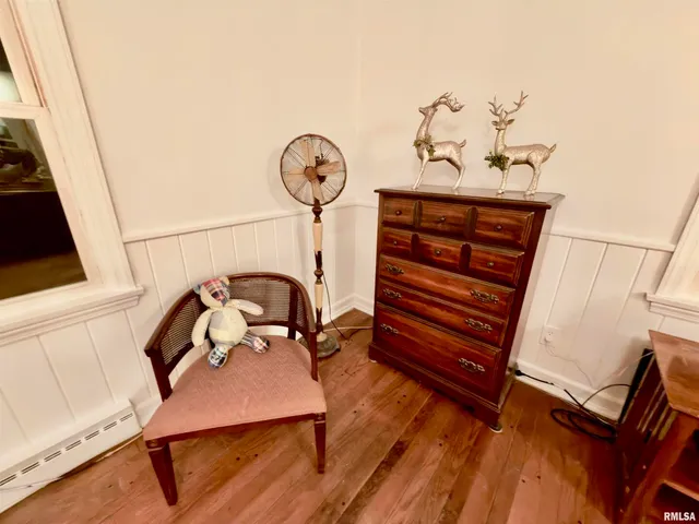 a view of a room with wooden floor and windows
