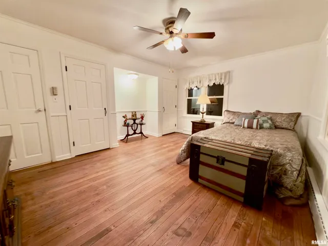 a view of a dry yard with trees in the background
