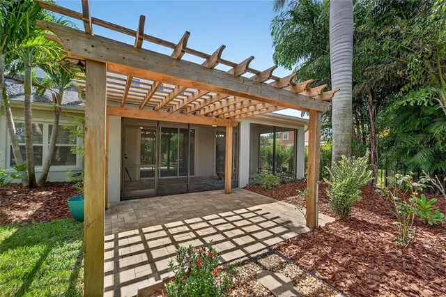 a view of a hallway with wooden floor and a living room