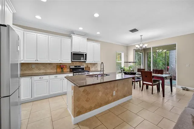 a kitchen with a stove and white cabinets