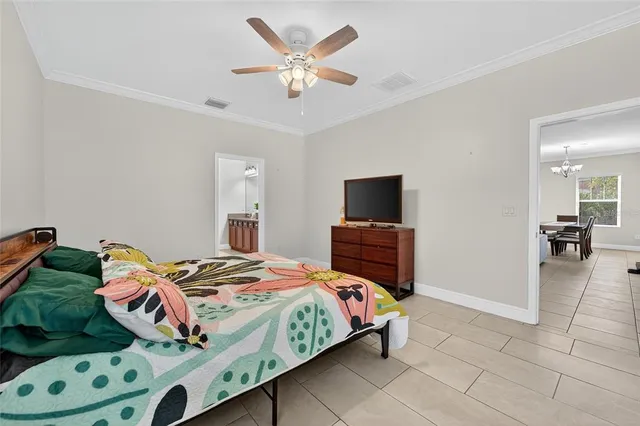 a bedroom with a bed and a chandelier