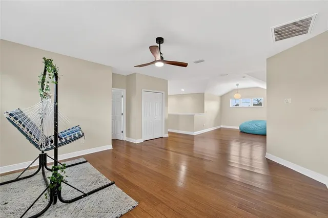 an aerial view of a house with swimming pool patio and lake view