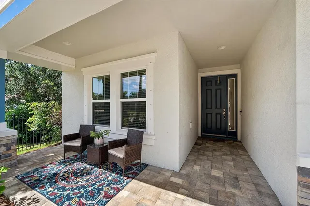 a view of a patio with a table and chairs under an umbrella