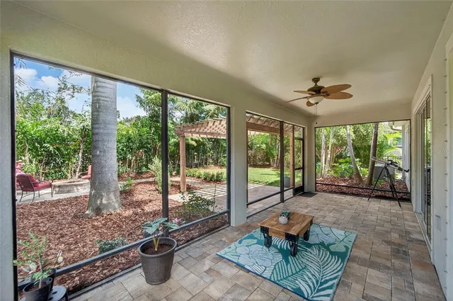 a front view of a house with a yard and potted plants