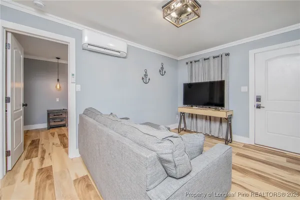 a living room with furniture and a flat screen tv