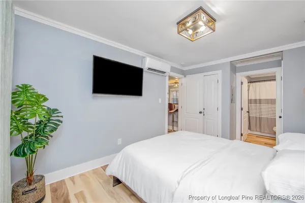 a bedroom with a bed and a potted plant