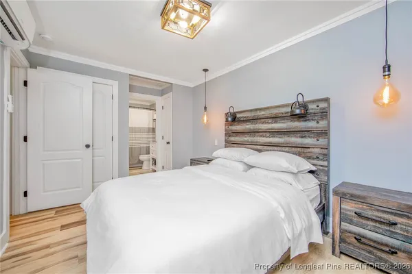 a bedroom with a bed and a chandelier