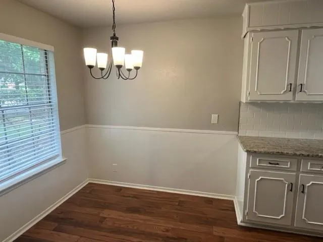 a view of a kitchen with wooden floor and fan