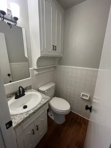 a bathroom with a sink toilet and mirror