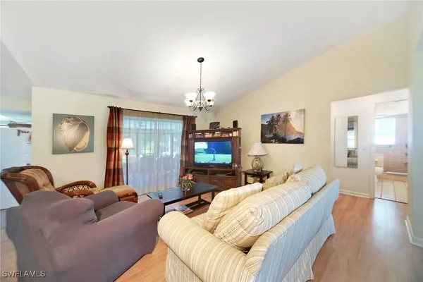 a living room with furniture and a chandelier