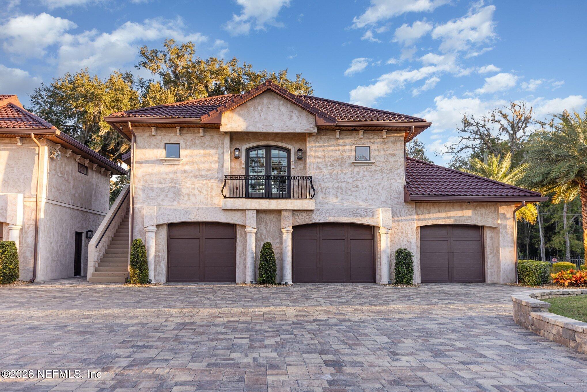 1402 Wilkies Point Road Green Cove Springs, FL 32043 - Photo 14 of 95 a front view of a house with a yard and garage