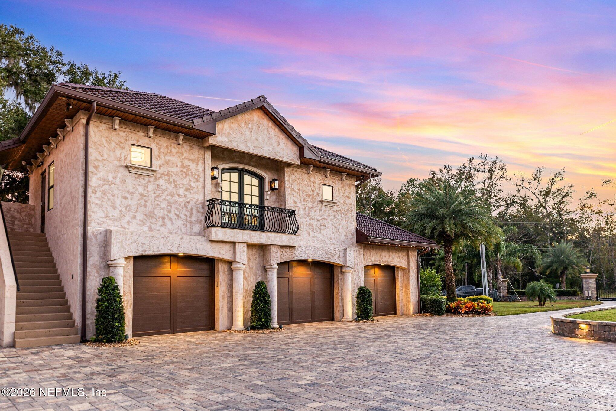 1402 Wilkies Point Road Green Cove Springs, FL 32043 - Photo 15 of 95 a front view of a house with a yard and a large tree